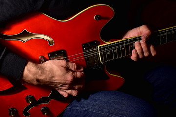 Man playing a electric guitar. Closeup, no face.