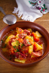 Delisious homemade stew. Goulash soup in a bowl on wooden table. vertical