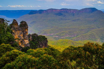 Fototapeta na wymiar Panoramic landscape view of iconic Three Sisters rock monument in Blue Mountains near Sydney, New South Wales, Australia. The most popular natural attraction. National park outdoor travel background. 