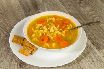 Bowl of Chicken Noodle Soup with Crackers