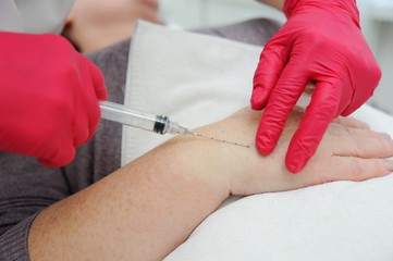doctor cosmetologist dermatologist conducts a session of mesotherapy or biorevitalization-removal...