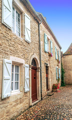 Medieval village of Aquitaine with its stone houses in the south of France on a cloudy day.