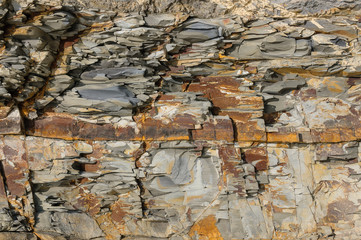 Texture of a dark yellow granite stone or background for design..The surface of the rock with a texture pattern for the tiles.