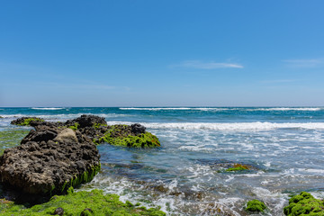 small waves breaking on the rocks