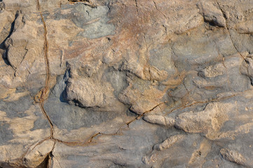 Brown stone with cracks on the surface or abstract background.