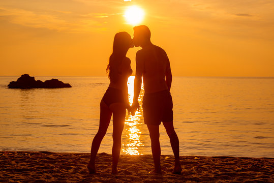 young couple is kissing at the sea