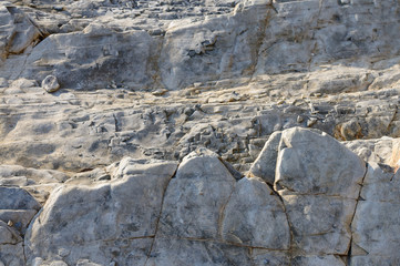The natural stone or the surface of the stone as a background texture is large..