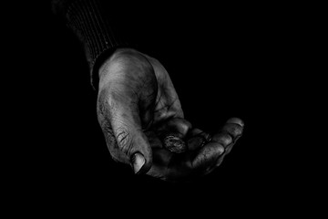 Helping hands concept, Old Man's hands palms up holding money coins, need care and support, reaching out, black and white