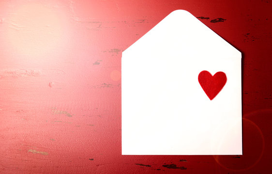 Happy Valentine's Day love letter envelope with red heart with lens flare and copy space for your text here.