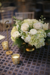 Wedding Photography Bridal Reception White Roses and Hydrangeas in a Centerpiece