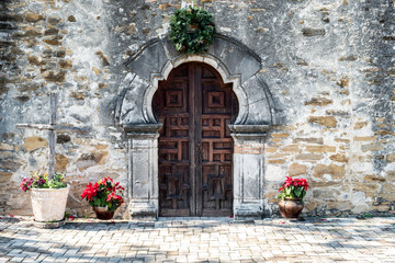Entrance door to Mission Espada in San Antonio Texas on a bright sunny day with christmas...