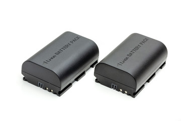 two black camera batteries on a white background