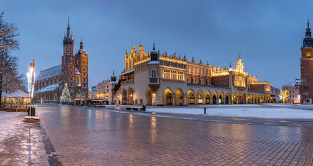 Krakow, Poland, main market square, winter night, St Mary's church and Cloth Hall illuminated