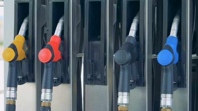 Male hand takes out a petrol pistol in the filling station