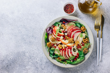 Healthy multi greens salad plate with apple, walnut, pomegranate, cheese
