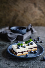 Cake with layer of sponge biscuits, blueberry jelly, and whipped cream