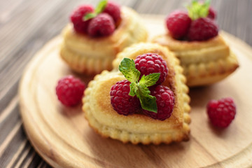Delicious heart-shaped muffins with raspberries and mint. Cupcakes for Valentine's Day