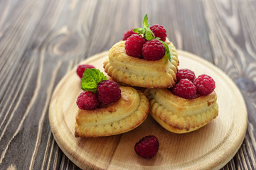 Delicious heart-shaped muffins with raspberries and mint. Cupcakes for Valentine's Day