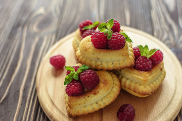 Delicious heart-shaped muffins with raspberries and mint. Cupcakes for Valentine's Day