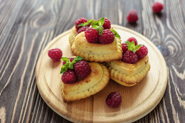 Delicious heart-shaped muffins with raspberries and mint. Cupcakes for Valentine's Day