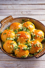 Buns Pampushky - Ukrainian garlic bread. Bread rolls with garlic and parsley in baking dish