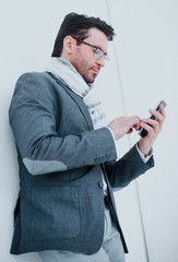 serious business man typing SMS on smartphone