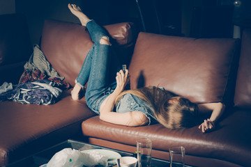 Young drunk woman on the sofa. Young drunk woman on the sofa. Alcoholism and drug addiction lead to...