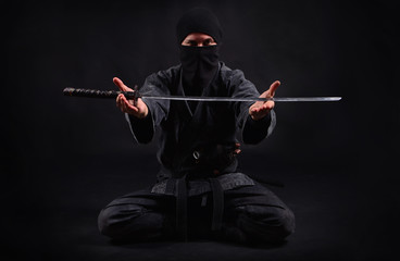 Ninja samurai holds katana in a hands © Dmytro