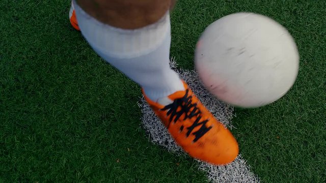 Soccer ball on the center point of a football field, a player starting the match, 4k slow motion
