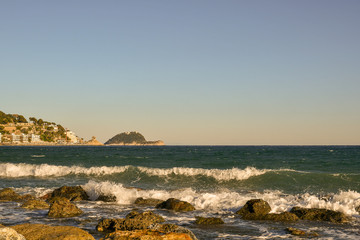Scenic view of the Ligurian Sea with rocks, Gallinara Island and Cappelleta chapel, Alassio, Liguria, Italy