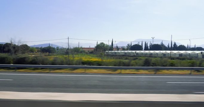 Olive plantations view from the train window and mountains while approaching to the Athens International Airport