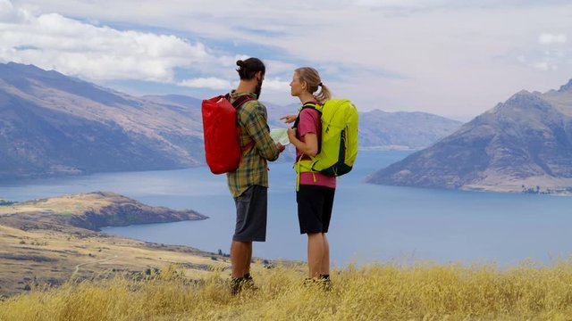 Couple reading map Fjordland Lake Wakatipu New Zealand