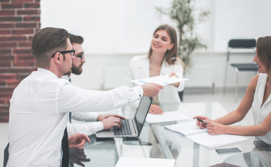 employees discussing business documents.