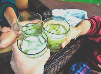 Friends toasting with Brazilian caipirinhas