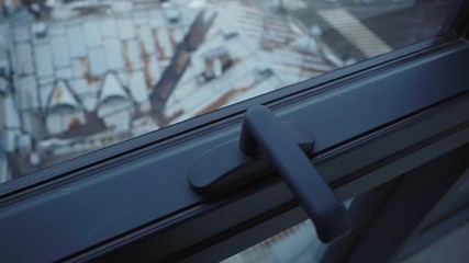 Roofs of old houses. View from the window of a skyscraper. Rusty metal roof with windows. Attic. Small European town. Quiet, uncrowded streets. Late autumn, winter. Bad weather. - Powered by Adobe