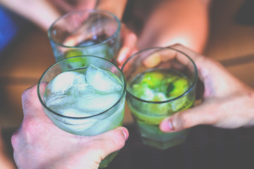 Friends toasting with Brazilian caipirinhas