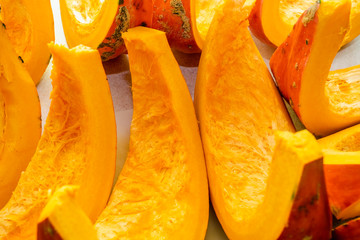 Raw pumpkin, Cucurbita, pieces on a table for cooking