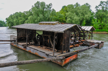 Fototapeta na wymiar Unique traditional boat mill on a river
