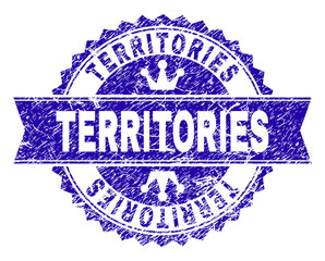 TERRITORIES rosette stamp seal watermark with distress texture. Designed with round rosette, ribbon and small crowns. Blue vector rubber watermark of TERRITORIES caption with retro texture.