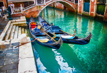 Fototapeta na wymiar Two gondolas on water of canal in Venice, Italy.