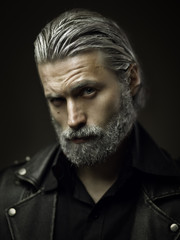 Portrait of tough old man in studio, shallow depth of field