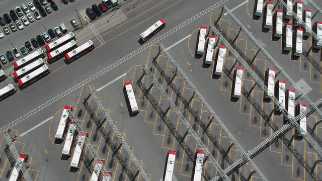 Parking garage of new buses. City public transportation buses parked in the bus bay. Aerial bird eye view.