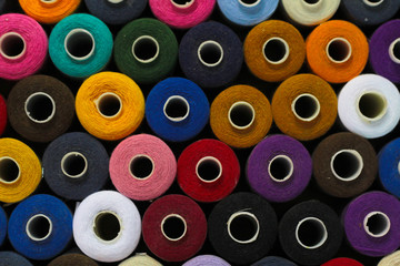 colorful spools of thread abstract background