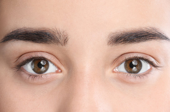 Young woman with beautiful natural eyelashes, closeup view