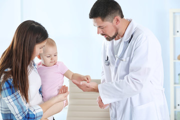 Woman with daughter visiting children's doctor in hospital