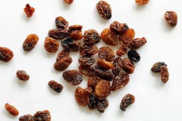 Heart made of raisins on white background
