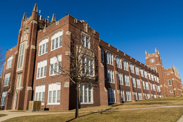 Fototapeta na wymiar Exterior of LaSalle/ Peru Township High School with brilliant blue skies in background. LaSalle/ Peru, Illinois, USA..