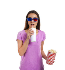 Emotional woman with 3D glasses, popcorn and beverage during cinema show on white background