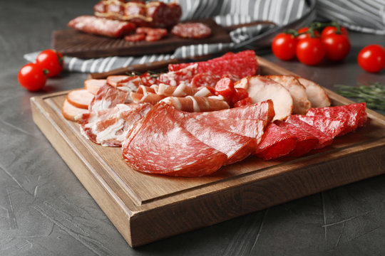 Cutting board with different sliced meat products served on table