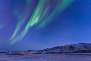 Fototapeta na wymiar The polar arctic Northern lights aurora borealis sky star in Norway Svalbard in Longyearbyen the moon mountains